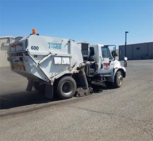 Parking lot cleaner cleaning a big parking lot