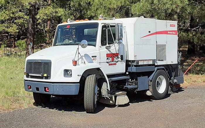 Swept Away AZ White Street sweeper vehicle