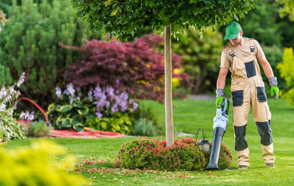 Men with Leaf Blower Cleaning commercial building landscaping